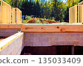 New home construction site with wooden framing set on concrete foundation 135033409
