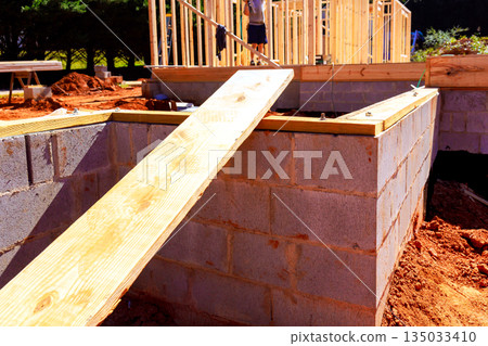 Workers build foundation for new structure beams wood, concrete blocks in construction site Workers build foundation for new structure beams wood, concrete blocks in construction site 135033410