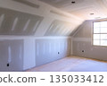 Freshly constructed room with drywall installation natural light pouring in from window 135033412
