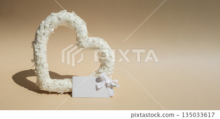 Empty white free space for advertisement template Symbol of love beautiful flower petals in heart shape in beige background. Creative concept of St Valentines day, weeding romantic date or anniversary Empty white free space for advertisement template Symbol of love beautiful flower petals in heart shape in beige background. Creative concept of St Valentines day, weeding romantic date or anniversary 135033617