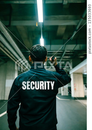 Security guards patrolling at night Security guards patrolling at night 135033693
