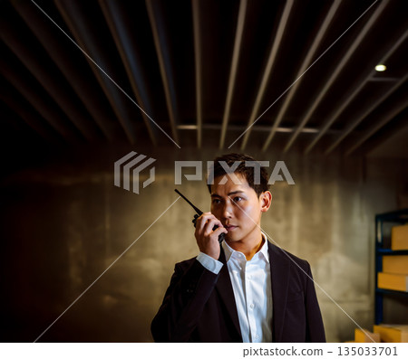 A man contacts by walkie-talkie A man contacts by walkie-talkie 135033701