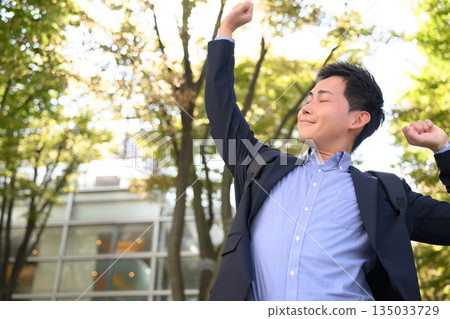 Businessman stretching and refreshing outdoors 135033729