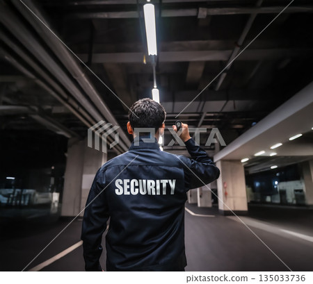 Security guard inspecting underground parking lot 135033736
