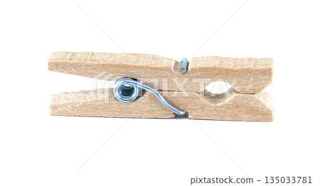 Classic wooden clothespin with metal spring, isolated on a clean white background 135033781