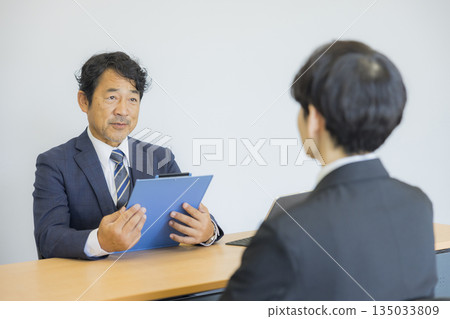 Businessman listening to a smile and talking 135033809
