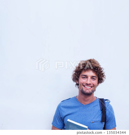 Happy student holding book 135034344