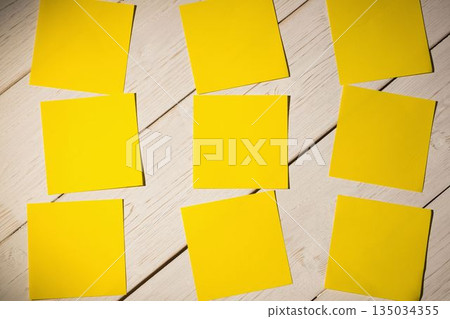 Yellow papers on wooden floor 135034355