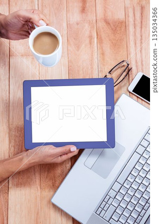 Overhead of feminine hand using tablet Overhead of feminine hand using tablet 135034366