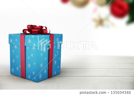 Flat design is featuring blue gift box tied with red ribbon on wooden tabletop, blurred ornaments 135034388