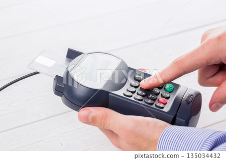 Man paying with credit card 135034432