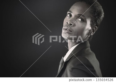 Thoughtful businesswoman against black background 135034526