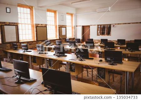 Flat design computer classroom is showing wooden desks with monitors, keyboards and sash windows 135034733