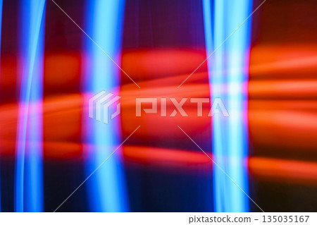 Abstract image features a blurred light painting technique, showcasing vibrant hues of red and blue in geometric shapes. The dynamic composition creates a sense of movement and energy 135035167