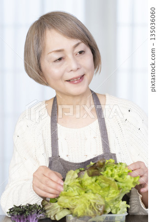 Senior woman enjoying kitchen gardening Senior woman enjoying kitchen gardening 135036060