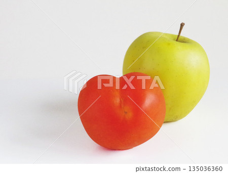 Heart-shaped tomato and yellow apple vegetables fruit 135036360