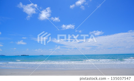 Tropical Ocean Horizon with White Waves and Blue Cloudy Sky 135037547