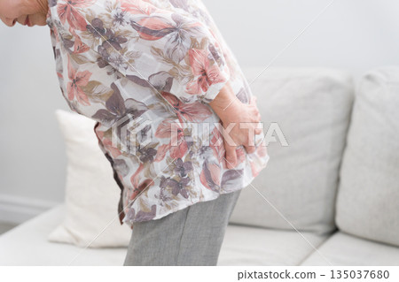 A woman in her 80s with back pain A woman in her 80s with back pain 135037680
