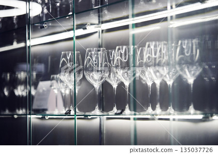 Crystal Wine Glasses on Illuminated Shelf, Close Up 135037726