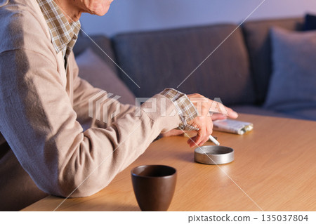 Senior man smoking a cigarette 135037804