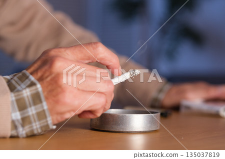 Senior man smoking a cigarette Senior man smoking a cigarette 135037819