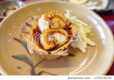 grilled Scallop in Matsushima fish market, seafood famous and popular of Matsushima bay in Miyagi Prefecture, Tohoku, Japan grilled Scallop in Matsushima fish market, seafood famous and popular of Matsushima bay in Miyagi Prefecture, Tohoku, Japan 135038079