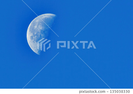 A white moon floating in the blue sky 135038330
