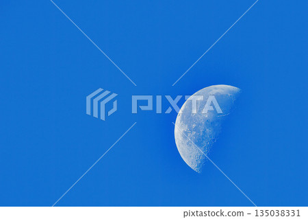 A white moon floating in the blue sky A white moon floating in the blue sky 135038331