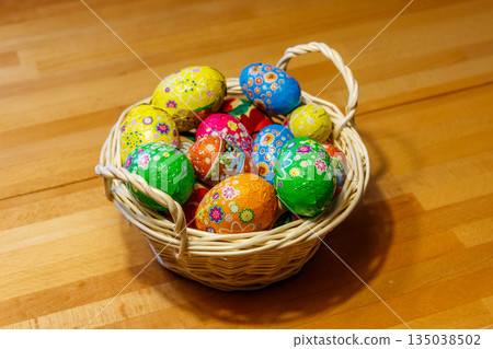 Basket with Easter eggs on wooden table 135038502