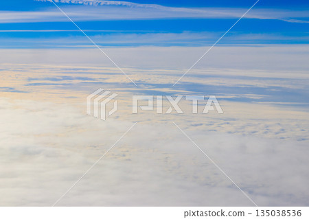 Beautiful white clouds in blue sky. View from airplane Beautiful white clouds in blue sky. View from airplane 135038536