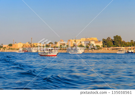 Tourist boat sailing on the Nile river in Luxor, Egypt Tourist boat sailing on the Nile river in Luxor, Egypt 135038561