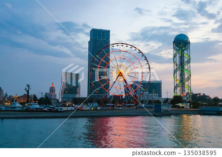 Batumi, Adjara, Georgia. View from the sea on illuminated resort town at evening Batumi, Adjara, Georgia. View from the sea on illuminated resort town at evening 135038595