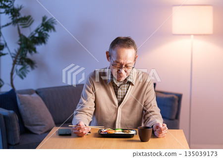 Senior man eating lunch alone 135039173