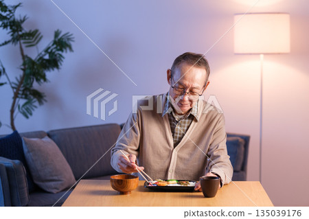 Senior man eating lunch alone Senior man eating lunch alone 135039176