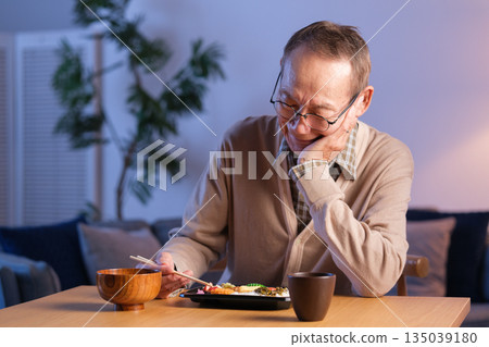 Senior man eating lunch alone Senior man eating lunch alone 135039180