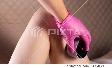 Doctor cosmetologist massage therapist does an anti-cellulite relaxing massage on a girl's body, close-up Doctor cosmetologist massage therapist does an anti-cellulite relaxing massage on a girl's body, close-up 135039333