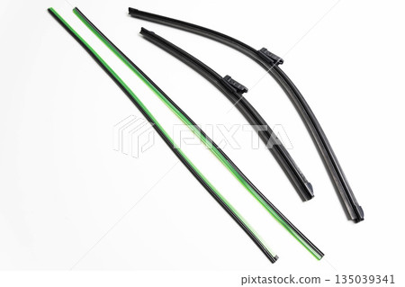 Car wiper blades with new rubber inserts for replacement on white background. Automotive parts for vehicle maintenance 135039341