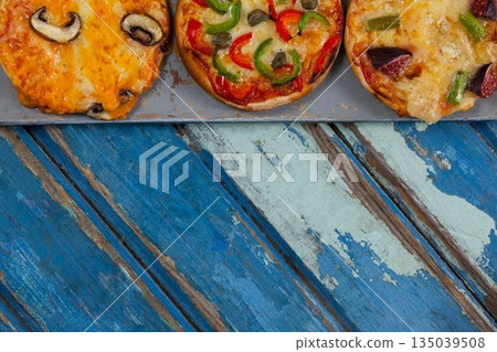 Cropped image of pizzas on weathered table Cropped image of pizzas on weathered table 135039508