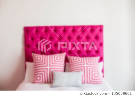 Pillows on bed against white wall Pillows on bed against white wall 135039661