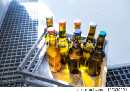 Beer bottles in crate on metal grate Beer bottles in crate on metal grate 135039964