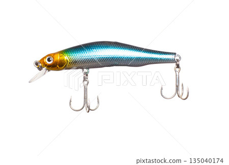 Metallic fishing lure isolated on white background. Hard bait minnow with shiny blue-green body, gold head, diving lip, and two treble hooks. 135040174
