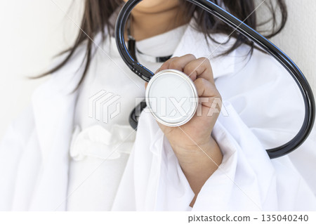 A 5-year-old girl (Japanese, faceless) wearing a large adult-sized white coat and holding a stethoscope A 5-year-old girl (Japanese, faceless) wearing a large adult-sized white coat and holding a stethoscope 135040240