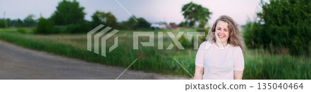 Portrait Of Beautiful Plus Size Young Woman In White Shirt Posing In Summer Field Meadow At Sunset Background Portrait Of Beautiful Plus Size Young Woman In White Shirt Posing In Summer Field Meadow At Sunset Background 135040464