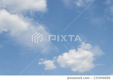 White clouds drifting across a vibrant blue sky on a sunny day White clouds drifting across a vibrant blue sky on a sunny day 135040800