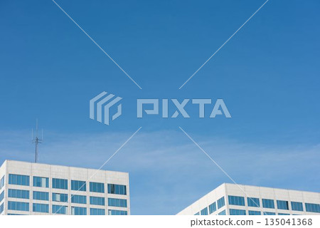View of office buildings against blue sky View of office buildings against blue sky 135041368
