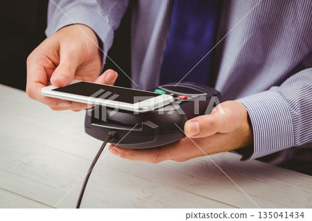 Man using smartphone to express pay Man using smartphone to express pay 135041434
