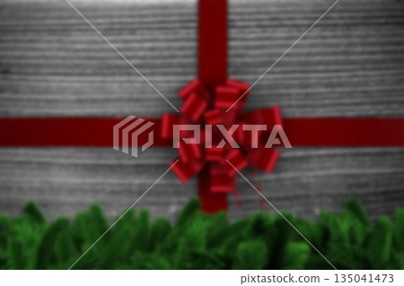 Flat design is displaying red satin ribbon crossed on woodgrain tabletop with bow and pine sprigs Flat design is displaying red satin ribbon crossed on woodgrain tabletop with bow and pine sprigs 135041473