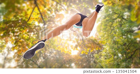 Directly below shot of sportsperson long jumping Directly below shot of sportsperson long jumping 135041504