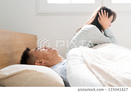 Wife woken up by husband's snoring Wife woken up by husband's snoring 135041827