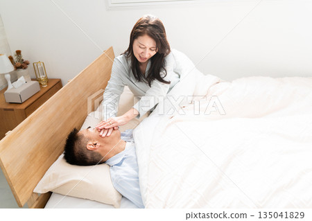 Wife woken up by husband's snoring Wife woken up by husband's snoring 135041829